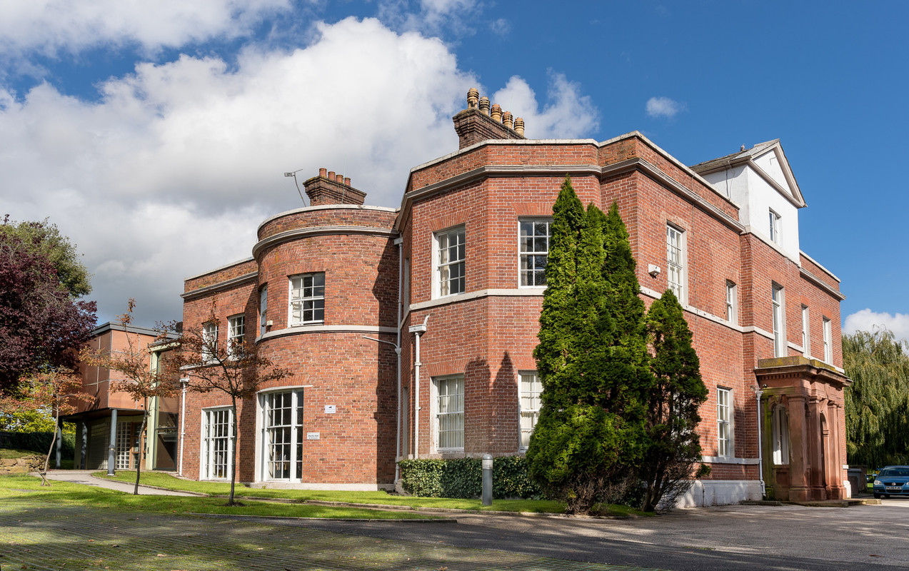 Bache Hall pictured from the outside with trees and landscaping surrounding the building