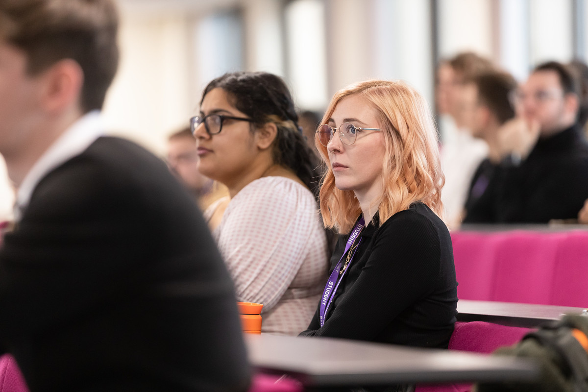 A group of students looking forward in a lecture room.