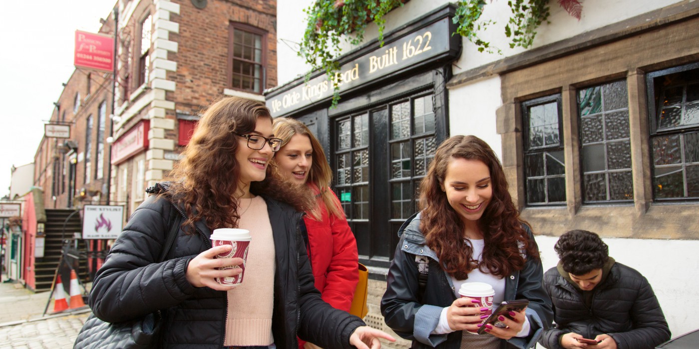 Students walking past ta historic pub