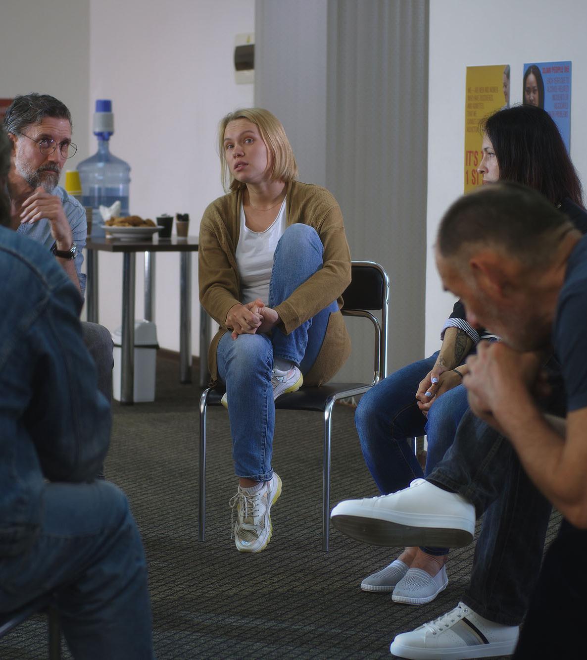Woman speaking about traumatic event during psychotherapy session.